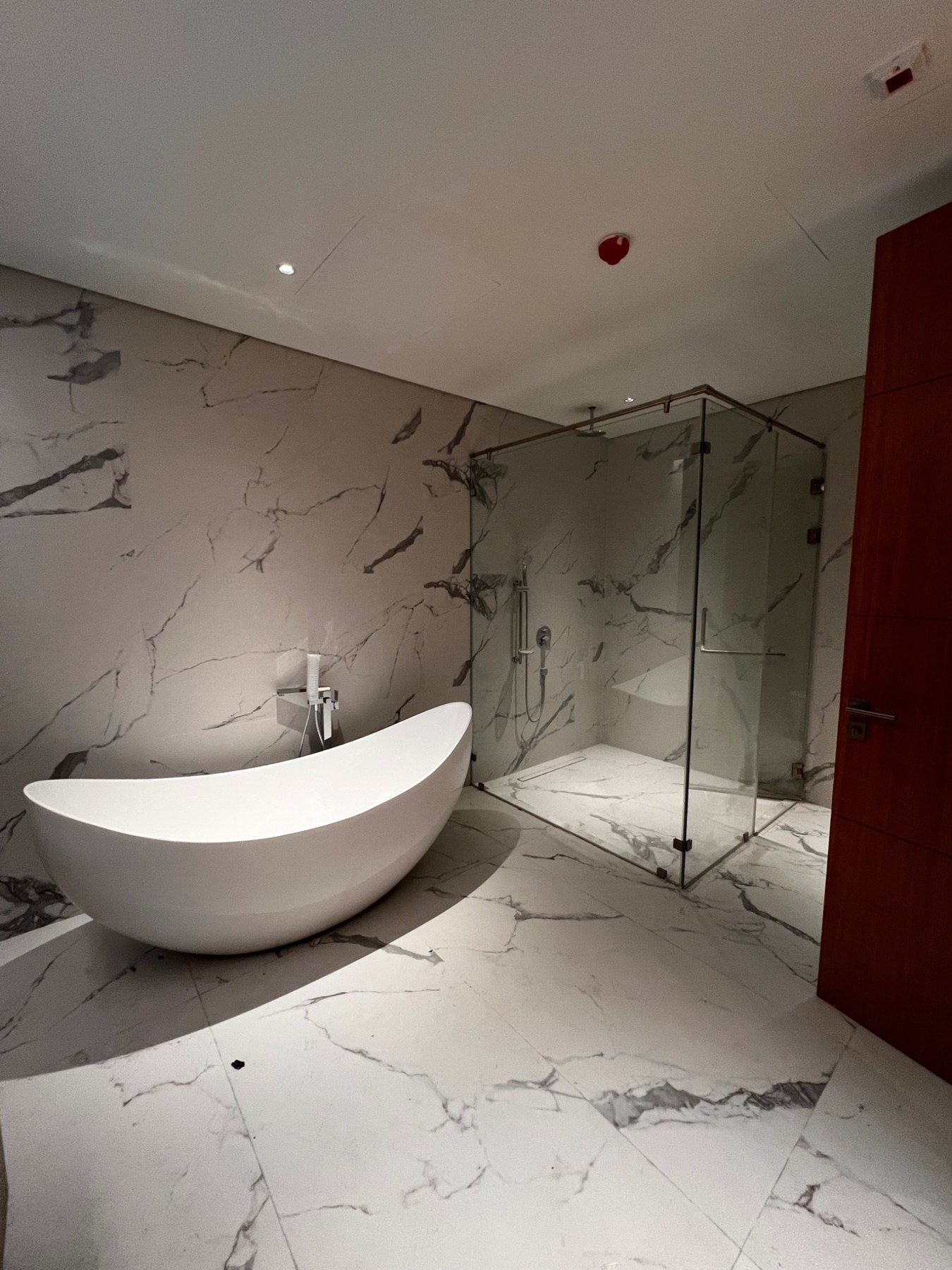 Profiletec bathroom fit-out with marble finishes, freestanding bathtub and glass shower